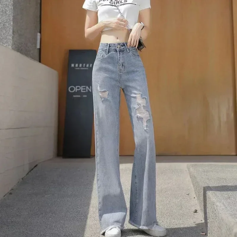 Celana panjang robek wanita, celana longgar kaki lebar dengan lubang Jeans dasar grosir Xxl Emo 2025 gaya Korea longgar celana koboi untuk wanita