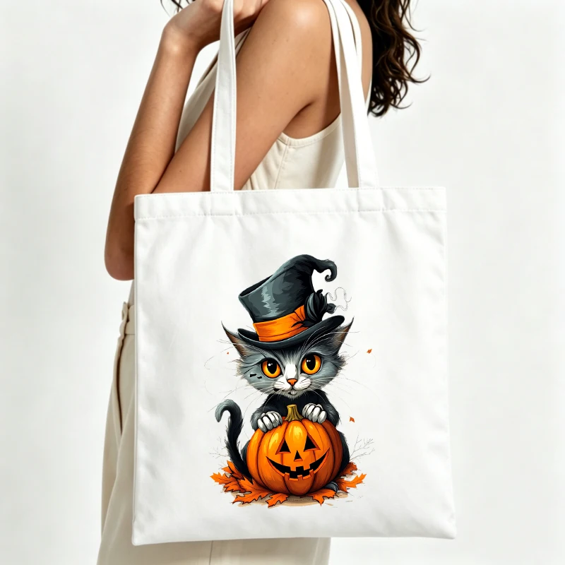 Women's Halloween cat with pumpkin graphic canvas tote bag, perfect for casual autumn outings and seasonal shopping