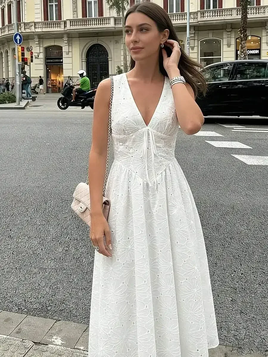 

White Sleeveless V-Neck Midi Dress Featuring Floral Eyelet Lace, Adjustable Front Tie Waist, And Flowy Silhouette For Casual