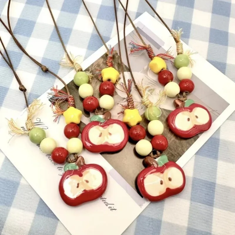 

Cute Apple Charm Neckalces Hand-painted Ceramic Apple Pendant Rope Necklaces Cartoon Apple Series Sweater Necklaces Wholesale