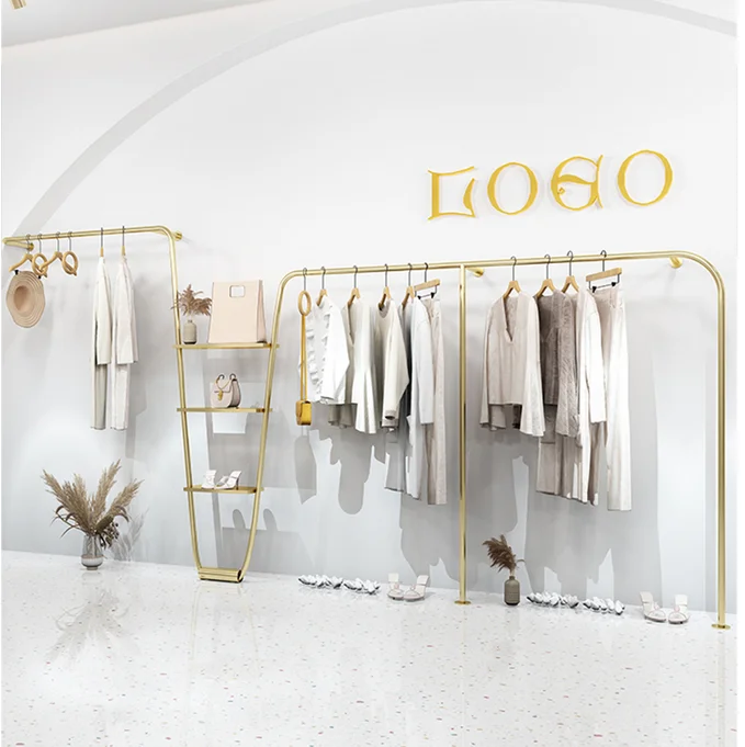 Stainless steel and titanium metal clothes racks are hung on the wall of the display rack in the clothing store