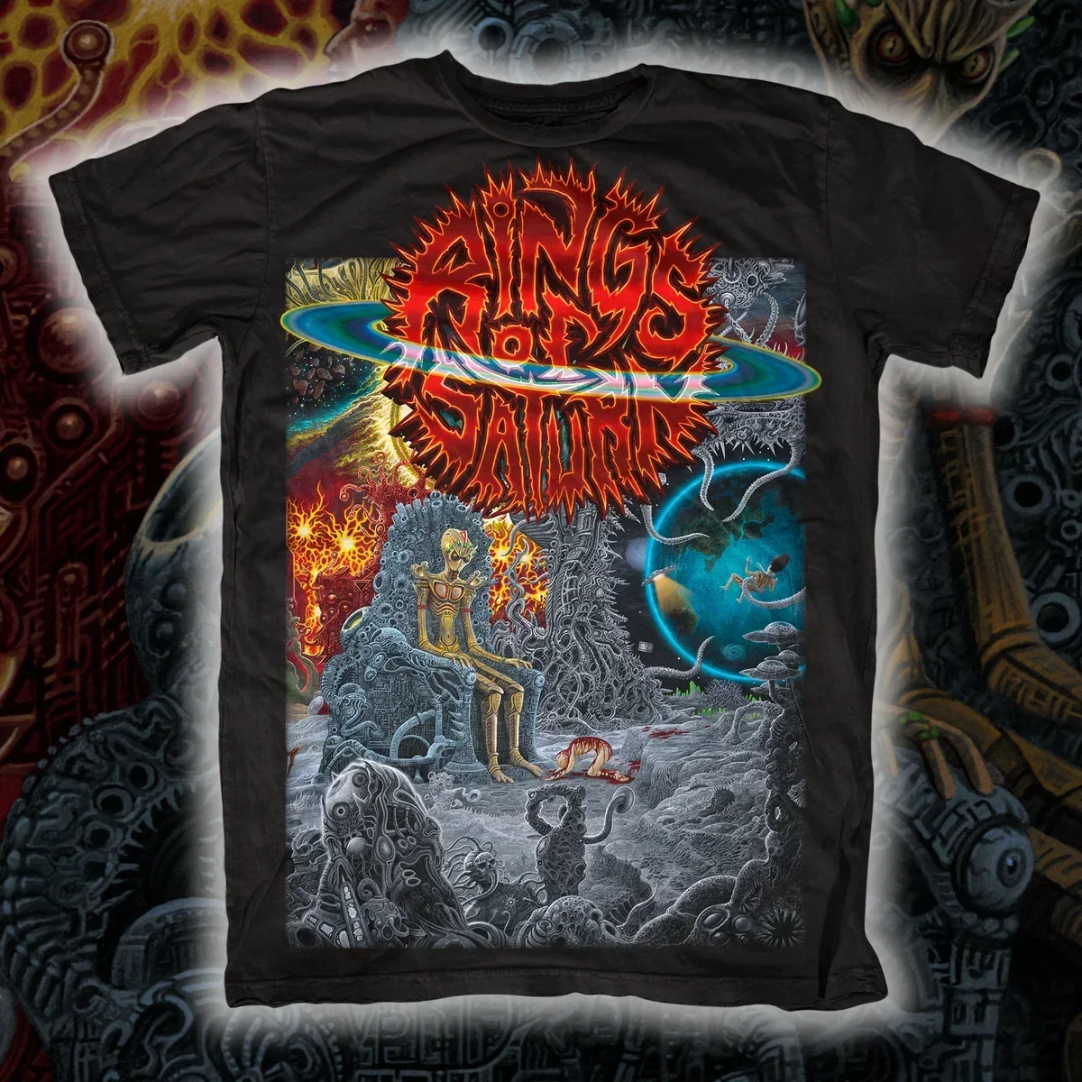 Rings of Saturn Alien King on Throne Cosmic Empire Graphic Print T‑Shirt, Features Red‑orange Spiky Band Logo with Colorful