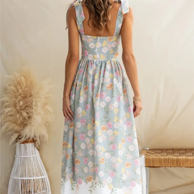 夏エレガントなノースリーブフラワープリントドレス弓サスペンダースクエアカラーハイウエストルーズ中空オフショルダービーチロングドレス