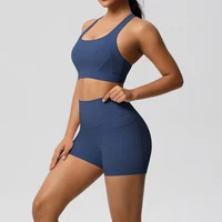 Women’s blue sports bra and high-waisted gym shorts shown from the side