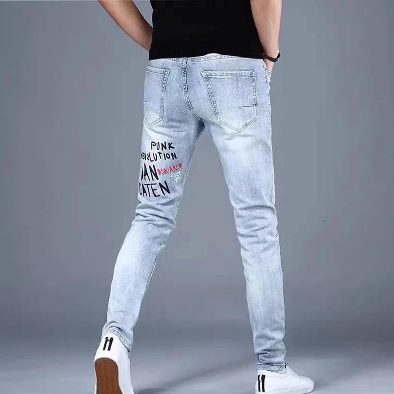 Moda Koreańskie Dżinsy Męskie Graffiti Nadrukowane Litery Spodnie Dżinsowe Męskie Streetwear Slim Fit Niebieskie Dżinsy Hip hop Małe Spodnie Stóp