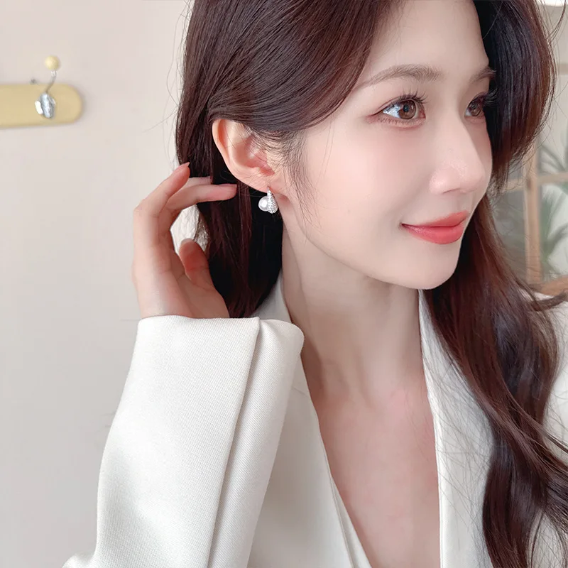 Il pendente, gli orecchini dal design di nicchia sono trendy, alla moda, eleganti e semplici, con un gancio per l'orecchio circolare e versatile