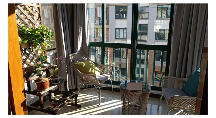 Nordic rattan chair set styled on a small balcony corner