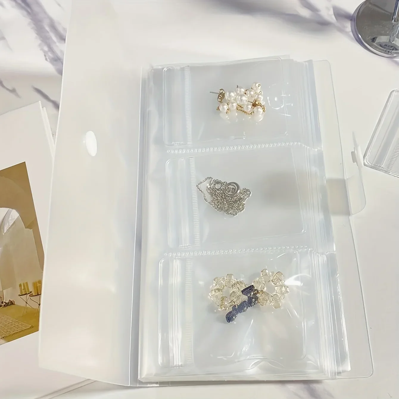 Libro per riporre gioielli trasparente a 84 celle, portatile, da viaggio, facile accesso, album fotografico, borsa per l'organizzazione dei gioielli