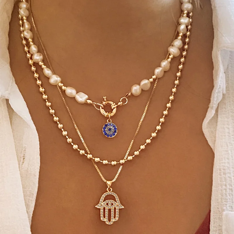 

New Alloy DiamondEncrusted Multi-Layer Necklace, Fashionable Pearl Eye And Palm Pendant. Women's Jewelry.