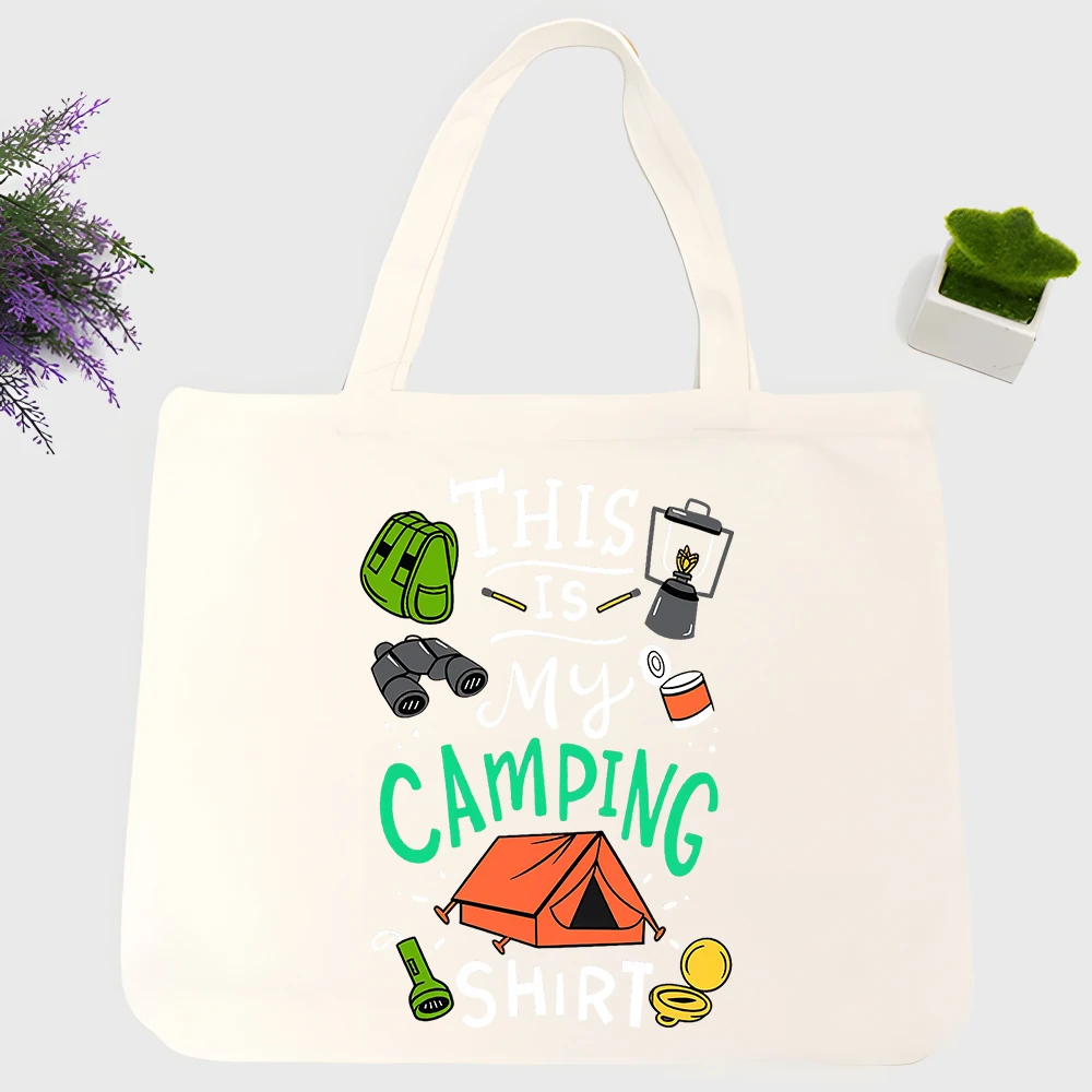 Camping enthusiasts' canvas tote bag with outdoor gear and tent graphic, casual style for weekend trips and outdoor adventures