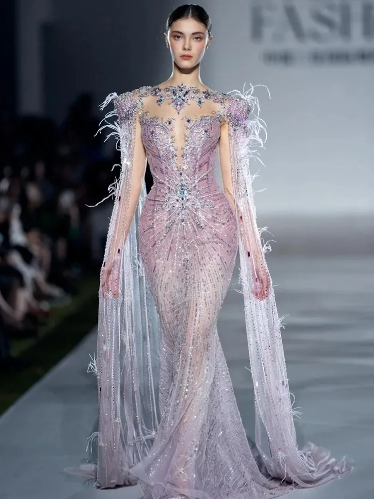 

A new fishtail flowing sleeve dress with heavy beaded and diamond-encrusted design exuding light luxury vibe