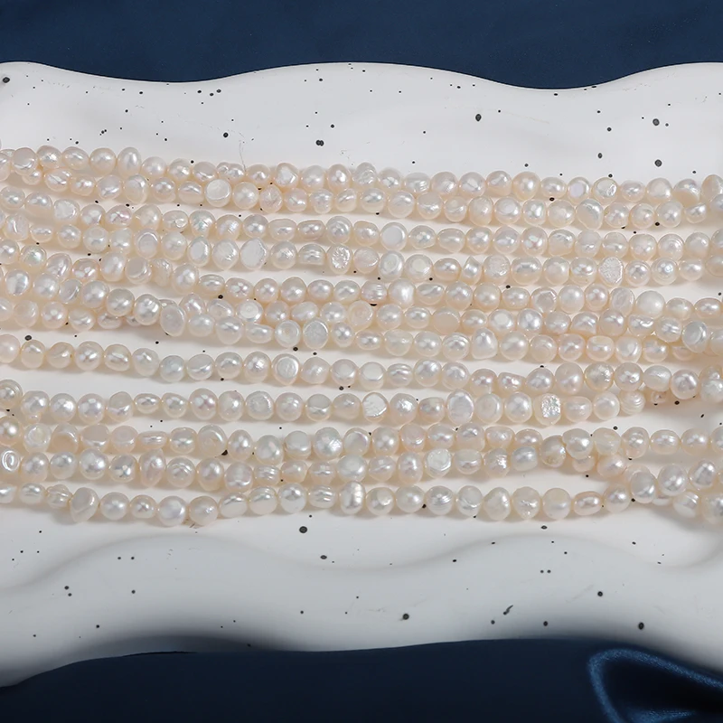 A strand of 5-6mm side-drilled, two-sided polished natural freshwater baroque irregular pearls, approximately 36cm in length.