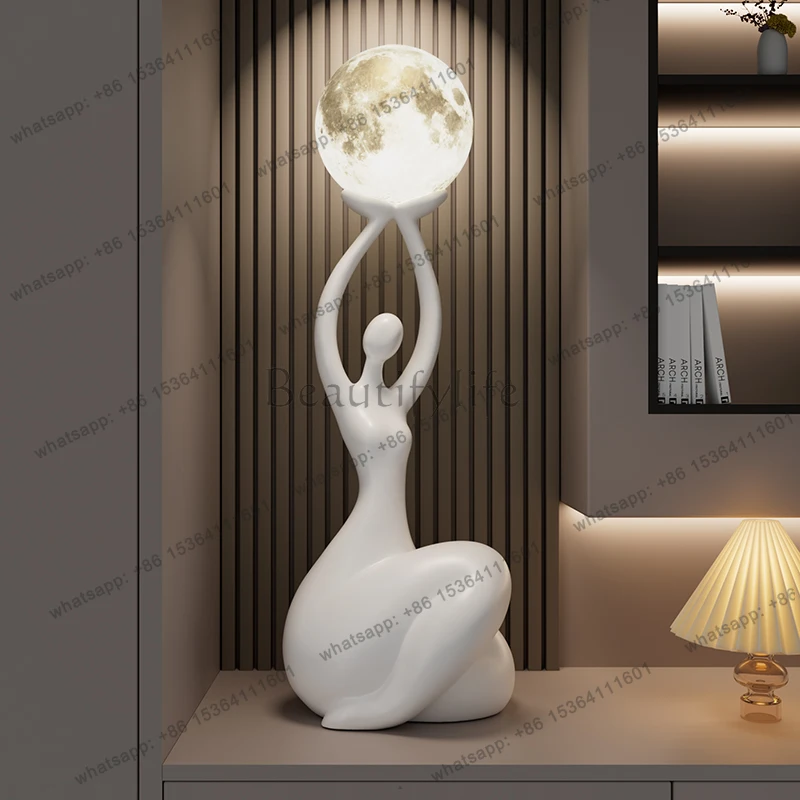 Abstract figure art ornament, high-end sense, floor-to-ceiling ambient light decoration next to modern TV cabinet