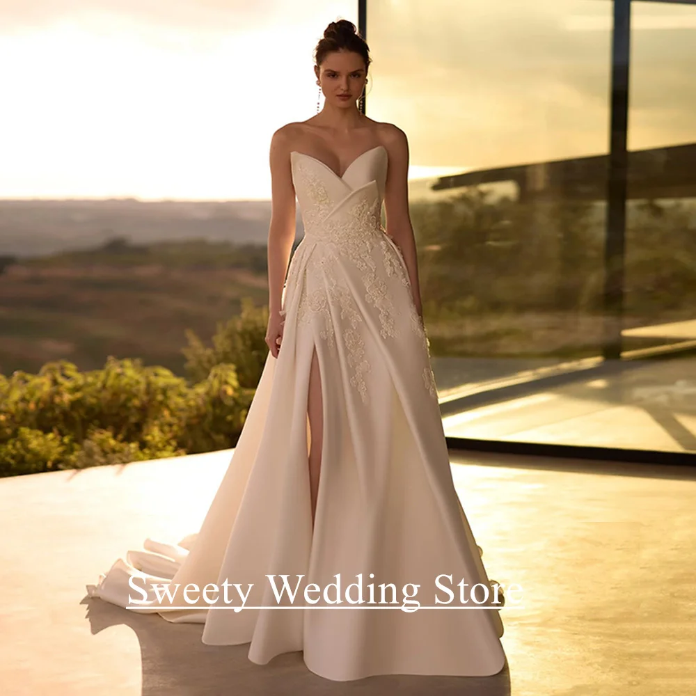 فستان زفاف مثير من الساتان للعروس مخصص على شكل حرف V بدون أكمام مزين باللؤلؤ بفتحة عالية على شكل حرف A فستان زفاف سويب تراين