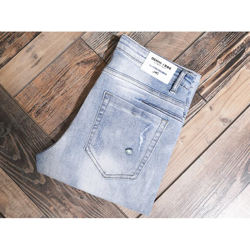 

Light colored casual jeans for men, slim fit with small feet and elastic Korean style trendy and versatile casual ripped pants