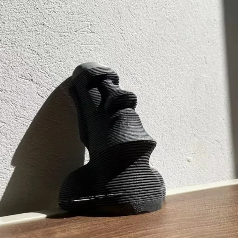 3D printed Easter Island statue in black and gray, with a movable toy and home ornament that can swing up, down, left, and right