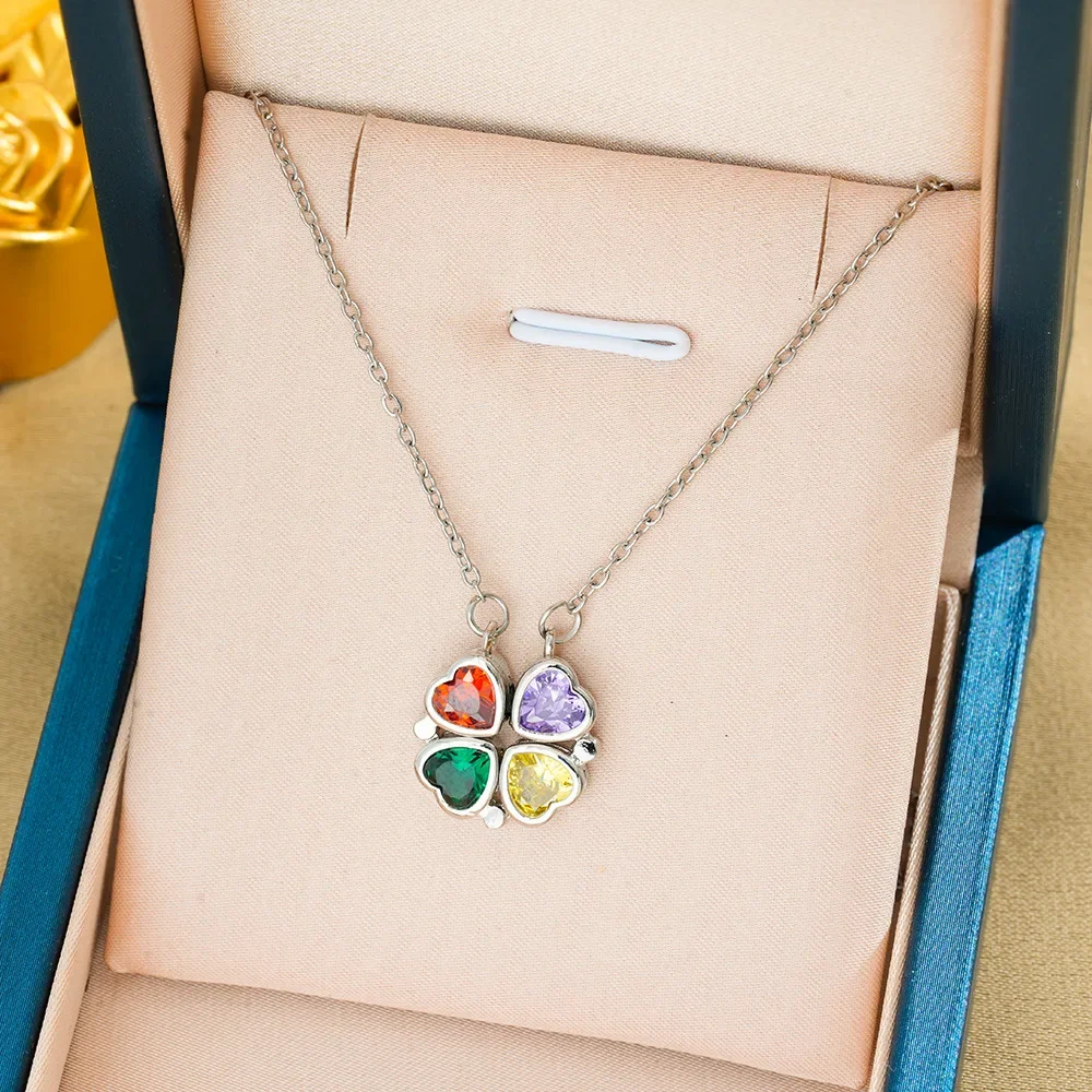 

Two fashionable heart-shaped necklaces are designed with zirconium four-leaf flowers blooming heart to heart.
