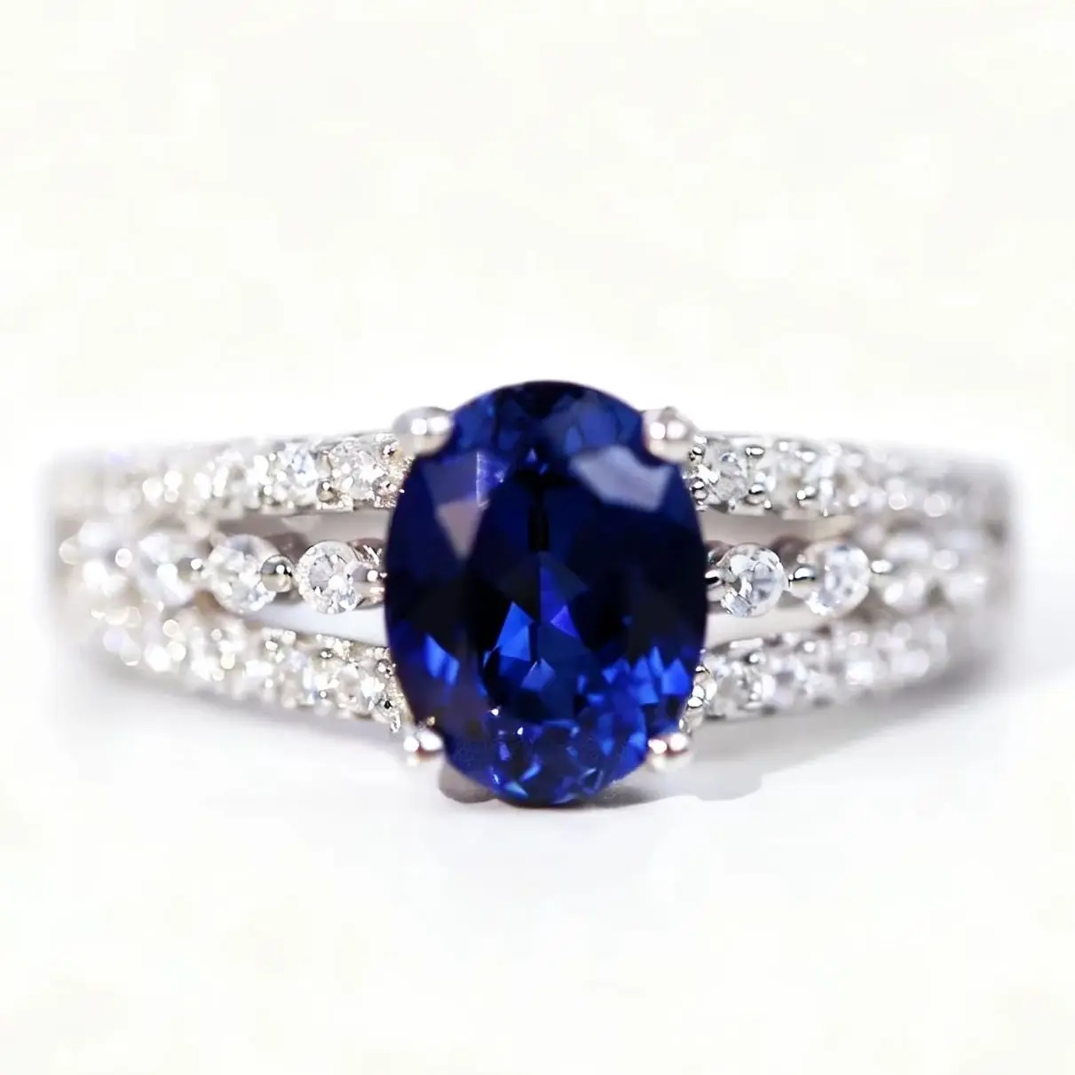 

Thick Rhodium Plated 925 Sterling Silver With Oval Lab-Grown Sapphire Ring with Triple imitation Diamond-Paved Bands
