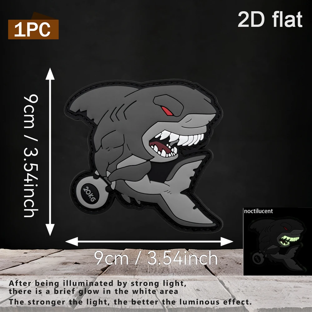 Available in 1pc/2pcs/3pcs options, 2D Dumbbell-lifting Fierce Shark PVC rubber with luminous effect, comes with a furry base, 3D embossed teeth area, strong light, glow-in-the-dark, luminous at night, gray-black contrasting color with red pupil design, waterproof, wear-resistant, not easy to fade, suitable for tactical vests, work backpacks, functional fitness, and fun decorative patches