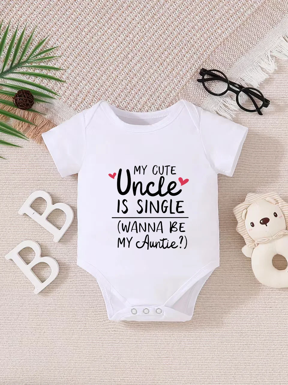 Playful letter-printed baby short-sleeve triangle bodysuit. Button closure for easy dressing, machine washable