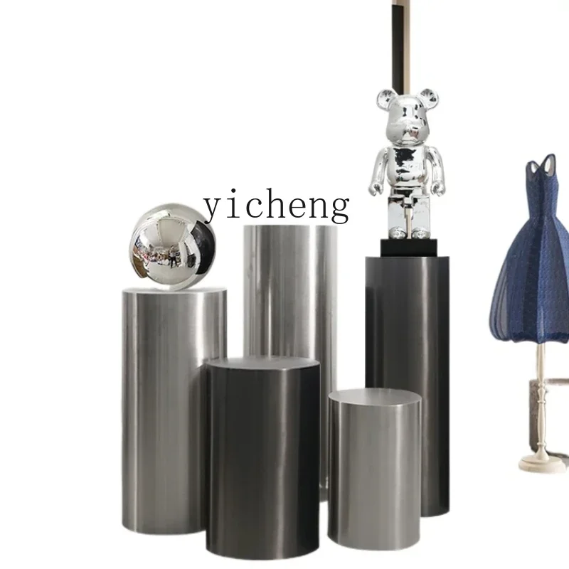 

cylindrical display stand model room TV cabinet next to floor round bottom stainless steel ornament