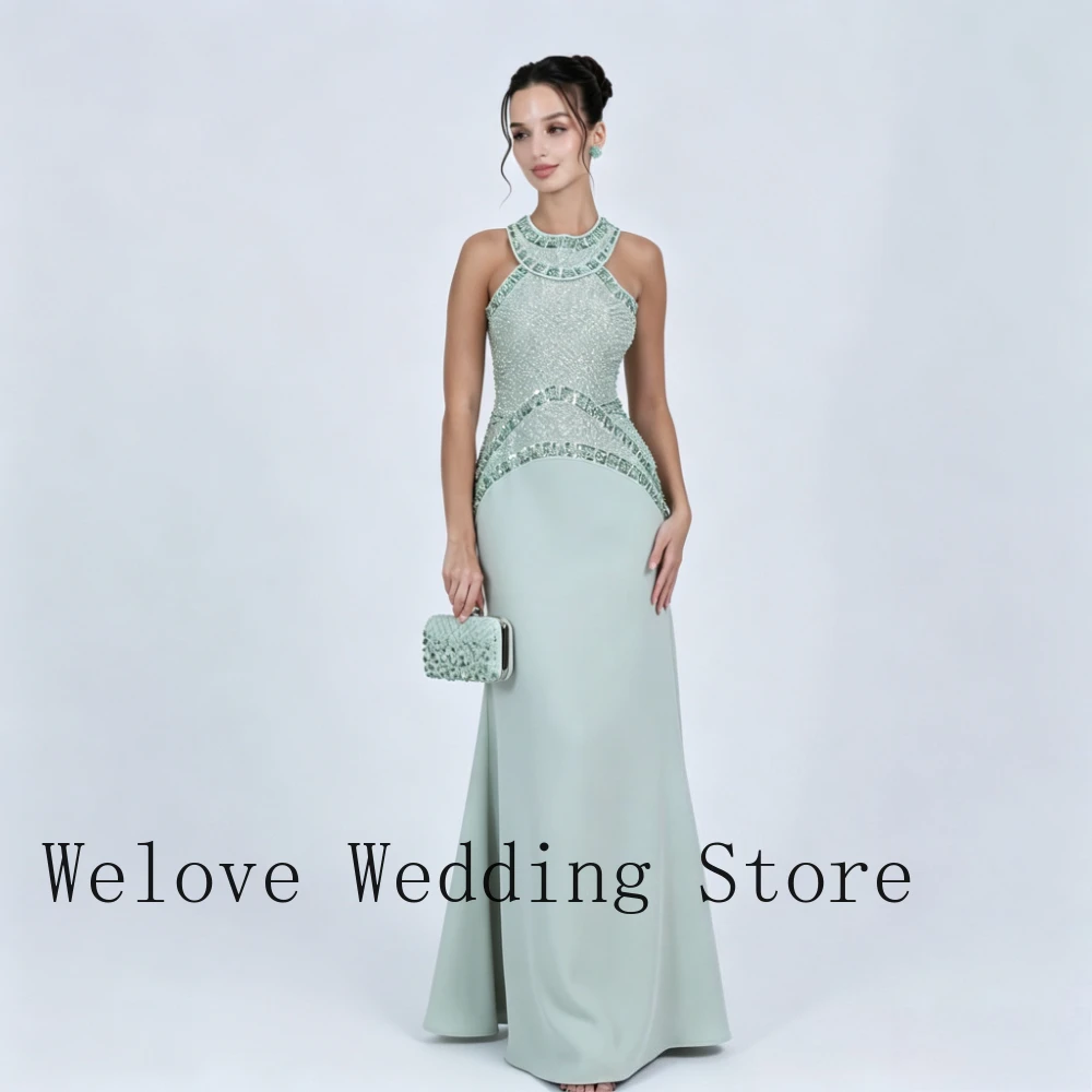 Green Formal Evening Dress with High Halter Neck Sleeveless Design Fully Beaded Bodice Sequined Waist Detail and Form-Fitting