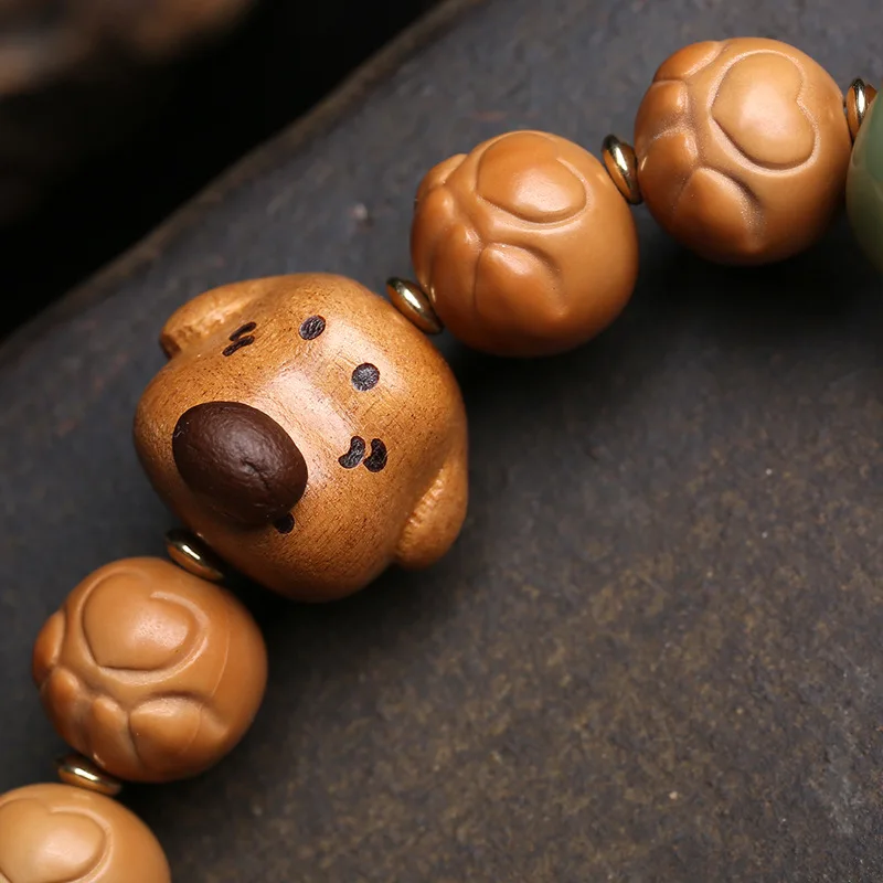 Natural,unpainted cat's paw and monkey head bodhi bead set;handheld peachwood bodhi root withcircular grooves and recessedridges