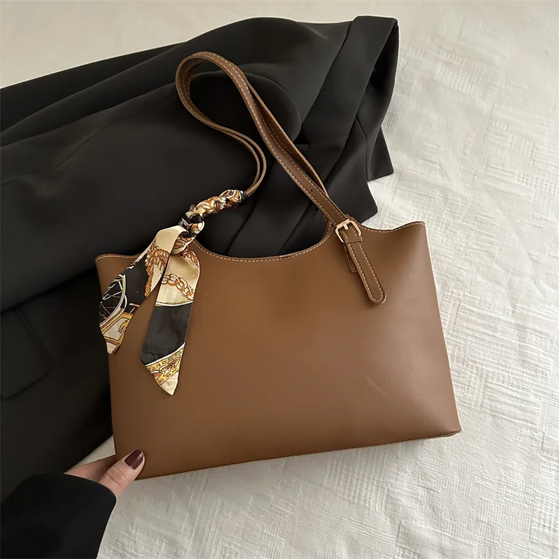 

An elegant tote adorned with a chic scarf. The versatile & stylish underarm bag for a graceful 2025 summer.