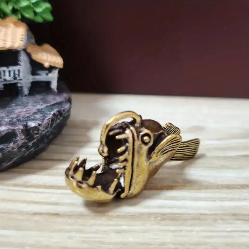 A vintage bronze fishing fish sculpture, a unique tea pet artwork, suitable for aquatic enthusiasts and home décor.