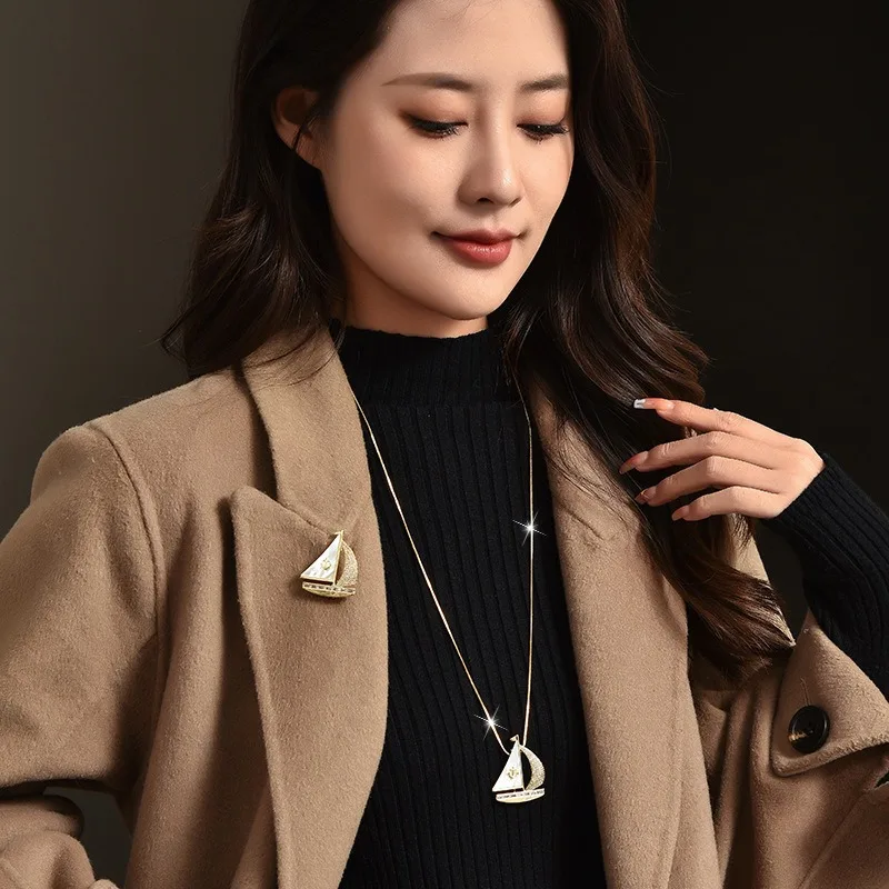秋冬の新しいロングネックレス、セーリングボート風のセーターチェーン、ツーピースドレス用のコサージュブローチ