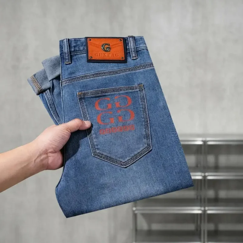 Luxury Style Blue Denim Jeans for Men, Straight Cut, Casual Pants with Orange Print & Contrast Leather Tag Design, Suitable for