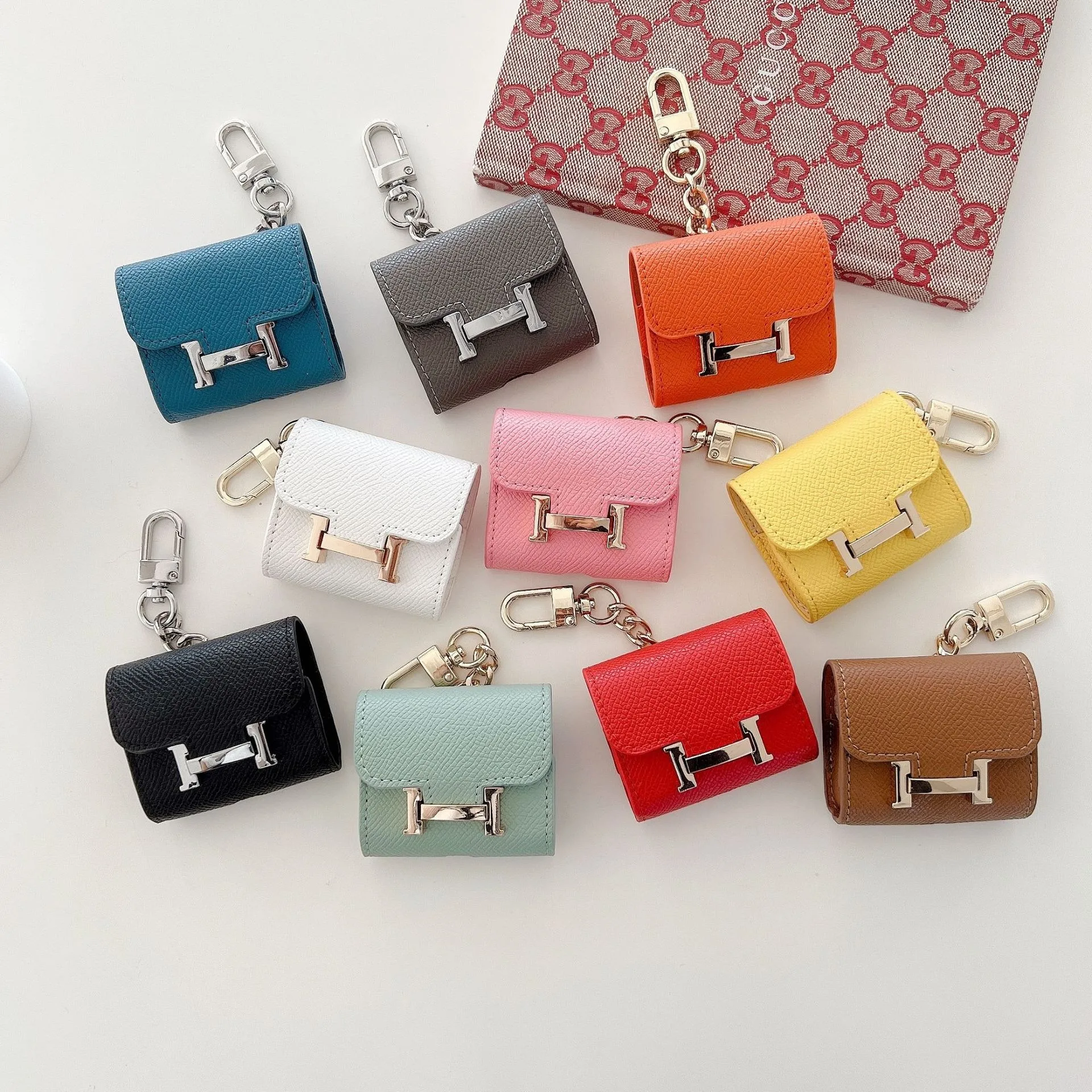 Mini earphone case with cute design, H-shaped keychain for bag accessory, suitable for AirPods 1/2/3 generation protective case.