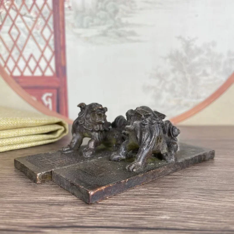 A pair of copper lion paperweights rulers, symbolizing virtue and capacity, decorative pieces