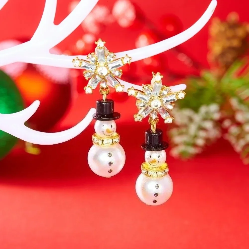 

Exquisite Imitation Pearl Christmas Earrings for Women, featuring a sparkling rhinestone snowflake stud paired with a cute snowman dangle charm.