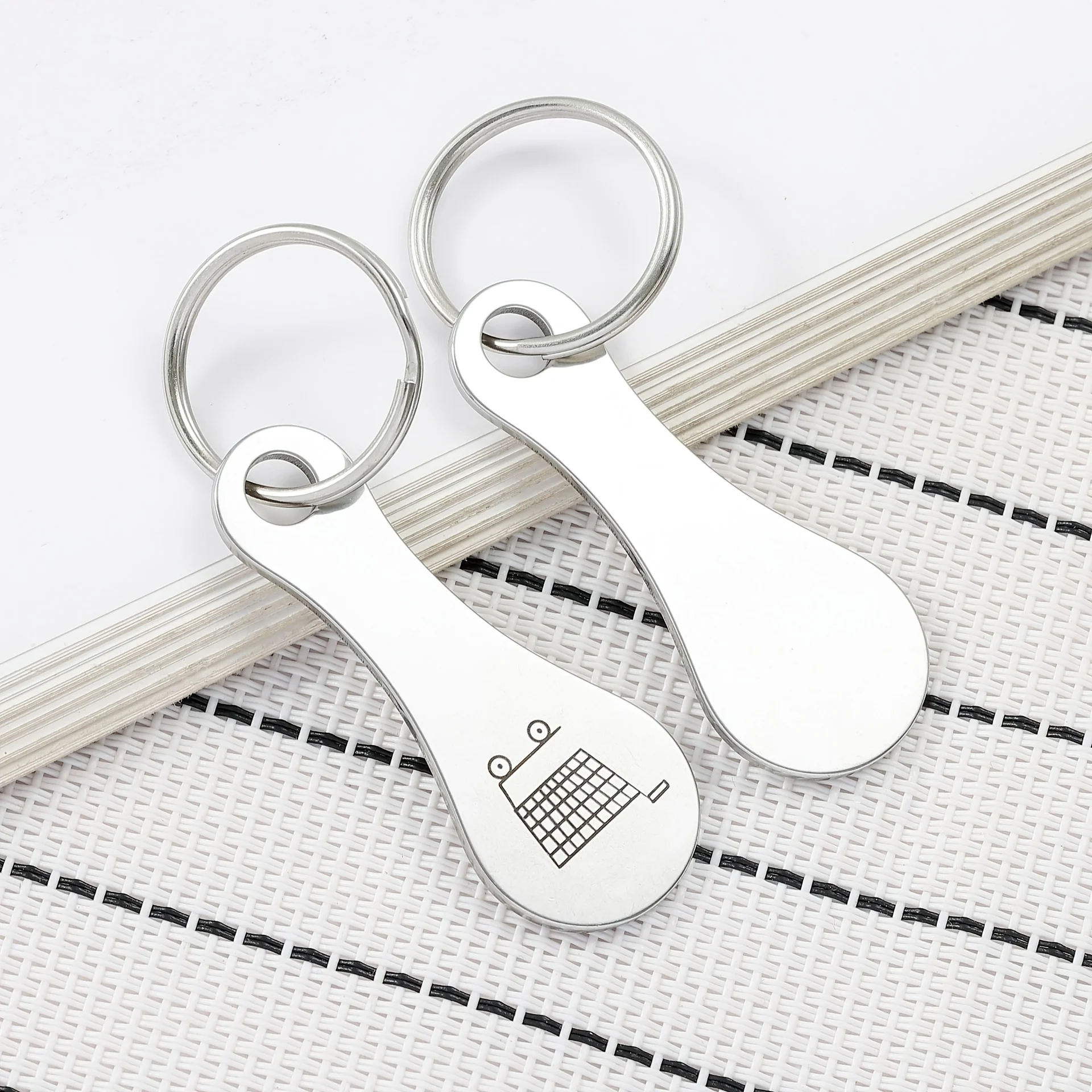 A Set of 2 Stainless Steel Shopping Cart Keychains, Featuring Shopping Cart Patterns