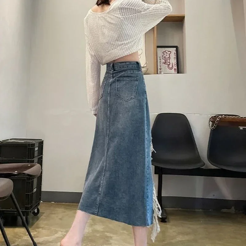 تنورة نسائية من قماش الدنيم بخصر عالٍ مع فتحة ممزقة تنانير جينز نسائية أنيقة وأنيقة فاخرة موضة كورية متواضعة لصيف 2025