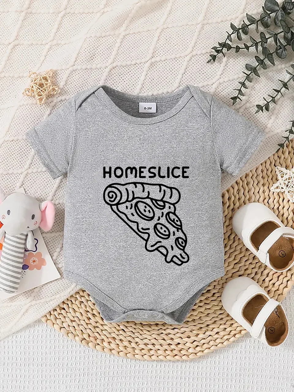 Playful letter-printed baby short-sleeve triangle bodysuit. Button closure for easy dressing