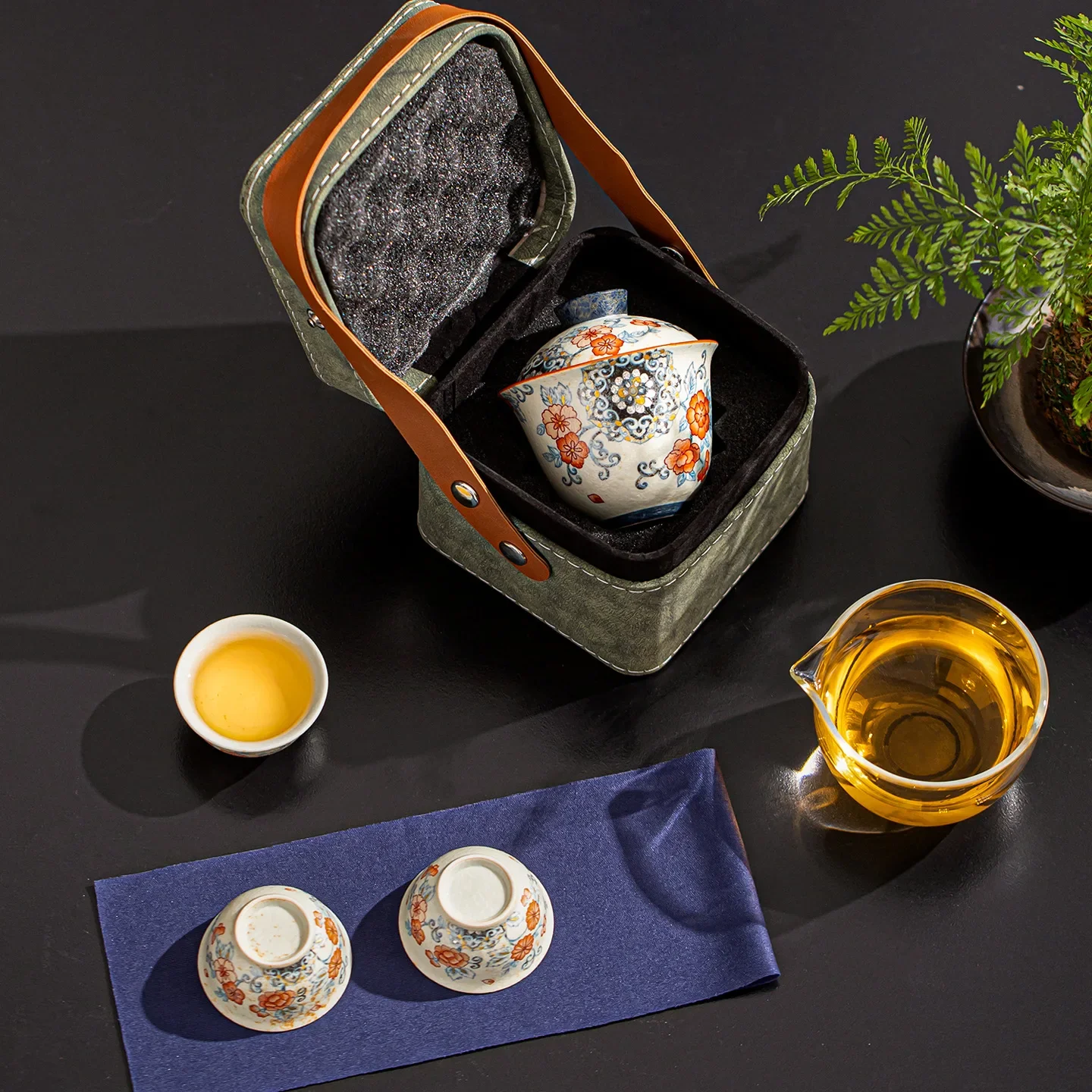 Blue white flint and red ingot covered bowl, one pot three cups, wrapped with lotus and treasure phase, travel portable tea set