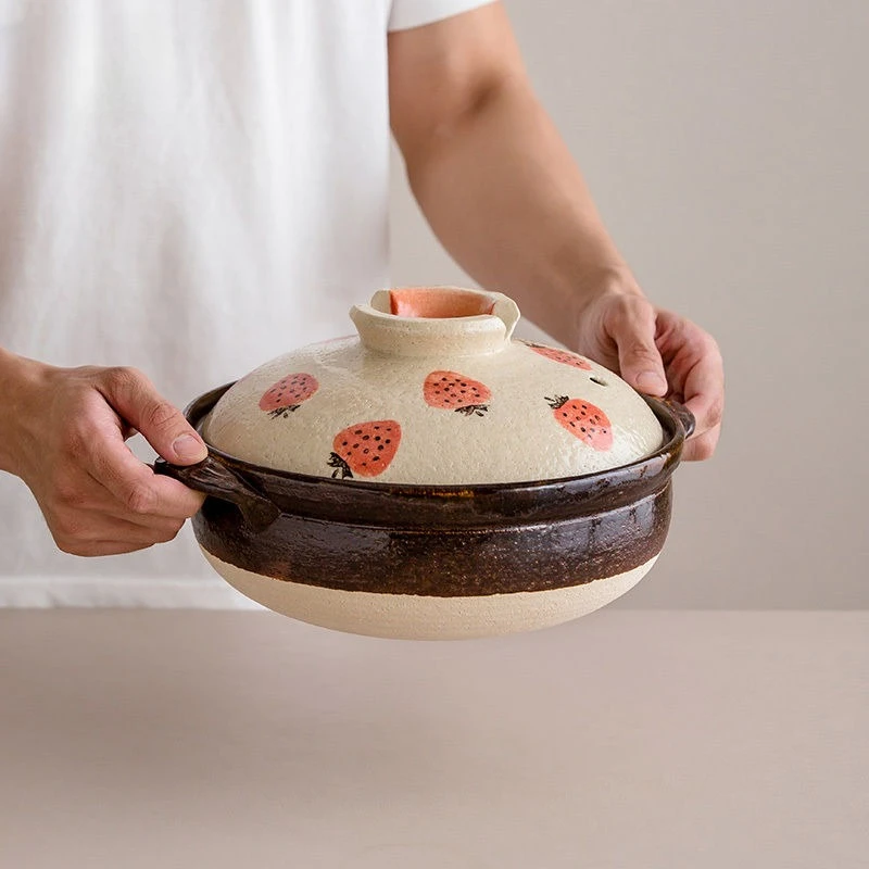 Cute pink strawberries, earthen pot Japanese style, home cooking rice, soup stew casserole
