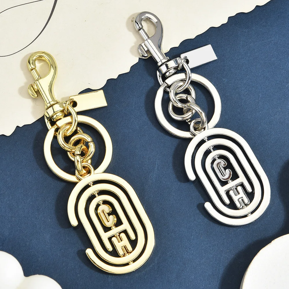 Gold Spinning Initial Handbag Charm Metallic Geometric Oval Keyring Luxury Purse Pendant Fidget Toy Personalized Gift For Women