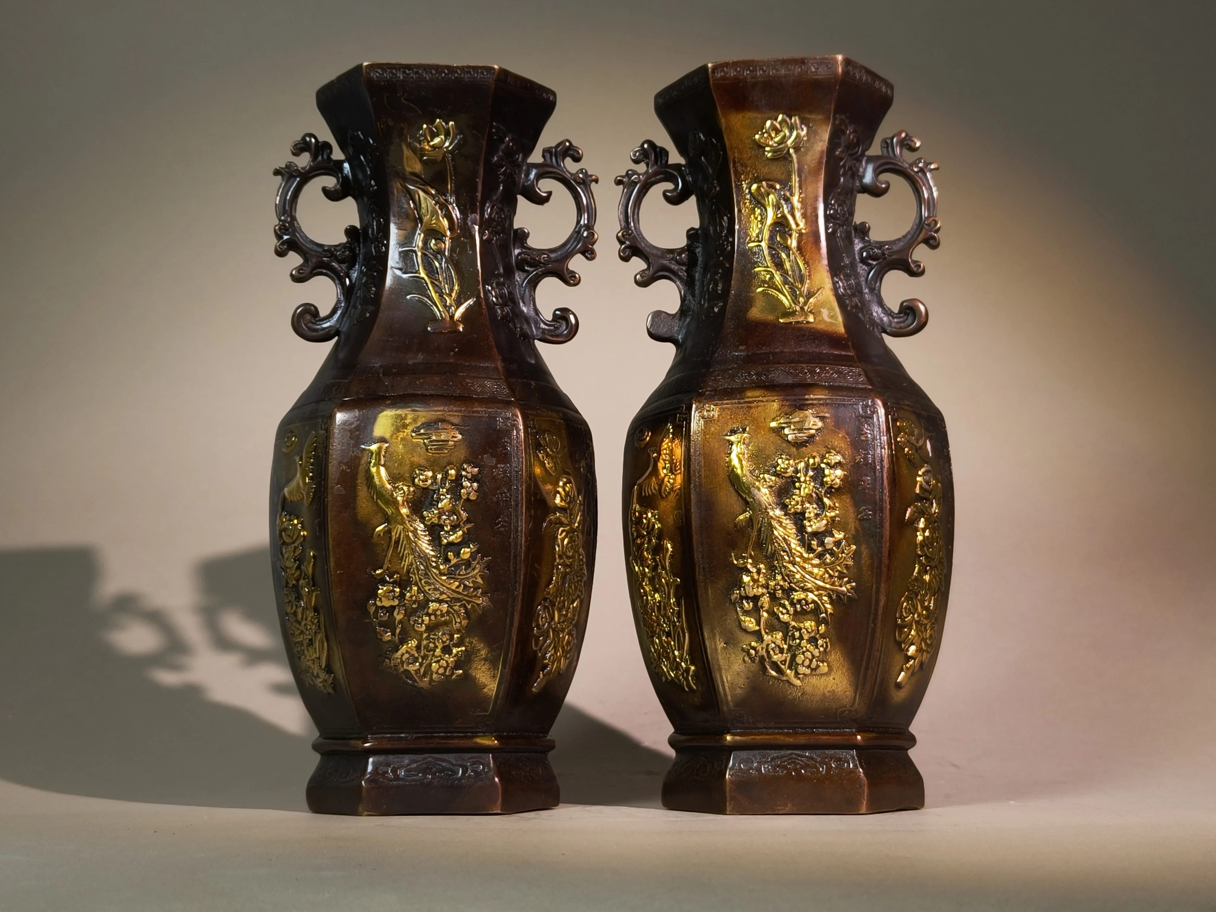 A pair of exquisitely hand-carved vintage bronze vases engraved with phoenix and peony patterns, antique collectible ornaments f