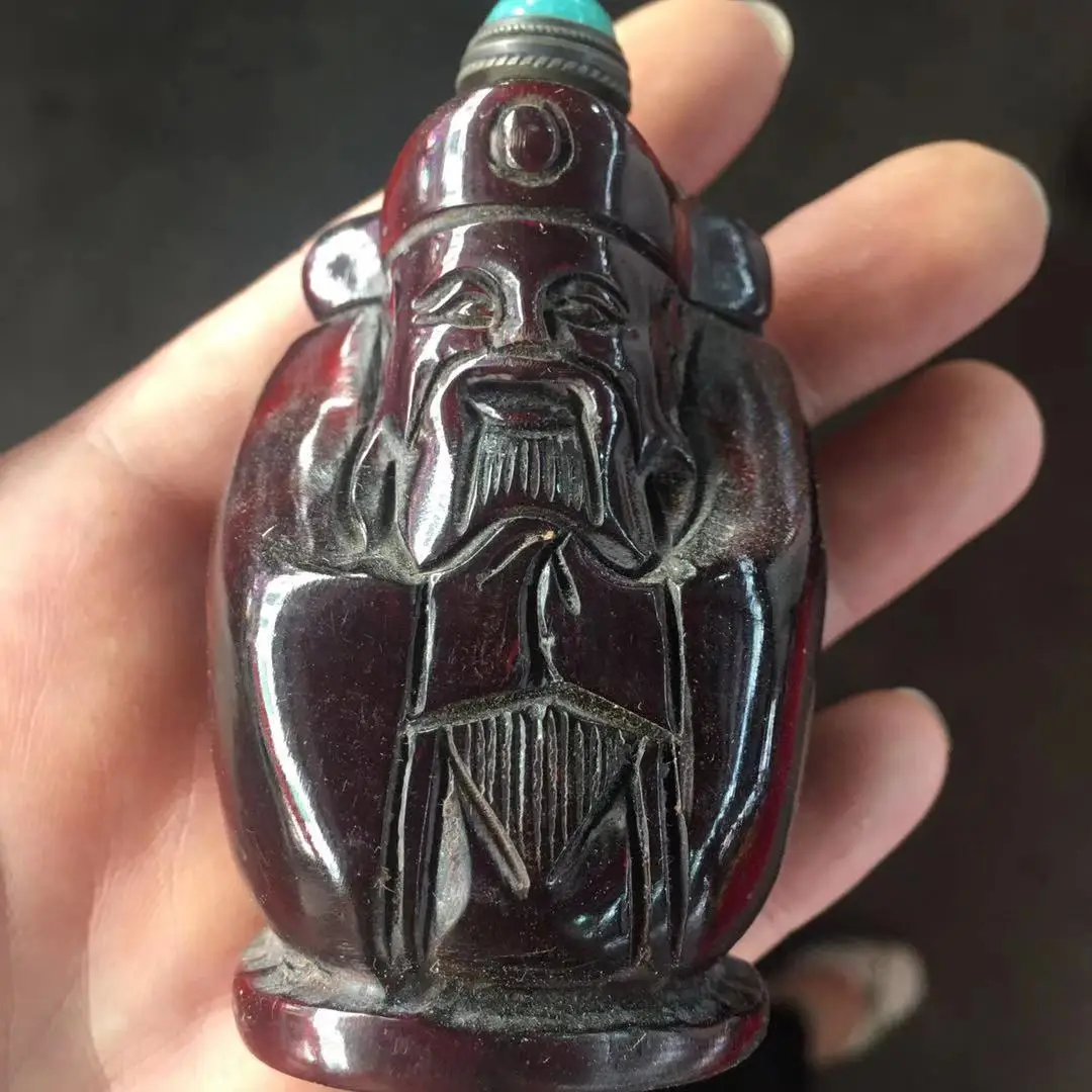 

Factory PriceMiscellaneous Wholesale Horn Red Transparent God of Wealth Inlaid Turquoise Snuff Bottle Trade Show Supply