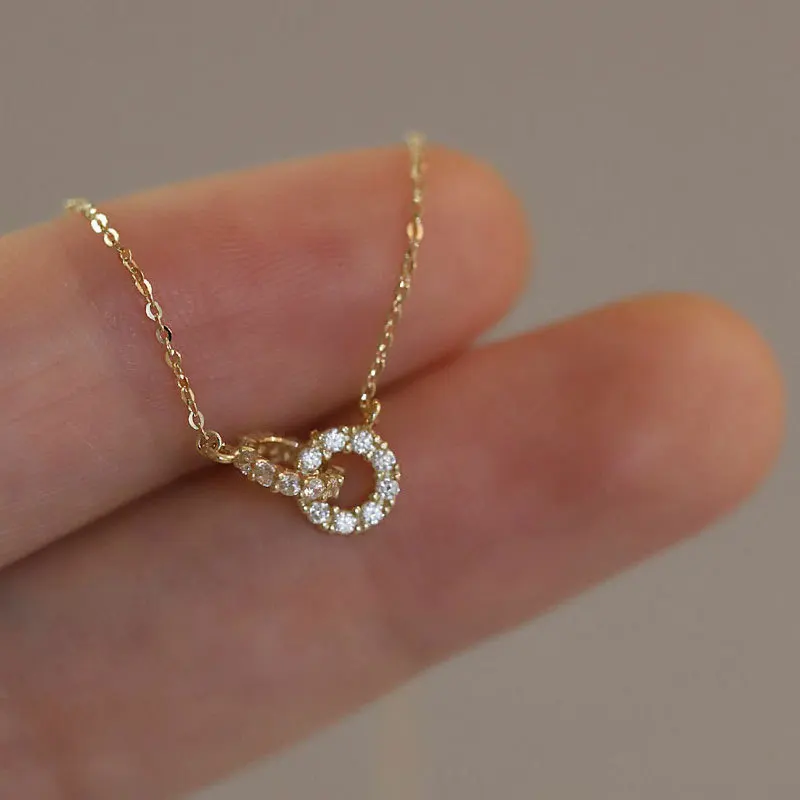 S925 silver geometric pendant necklace featuring dual interlocked rings with diamond accents, 18K gold or white gold plating, O-
