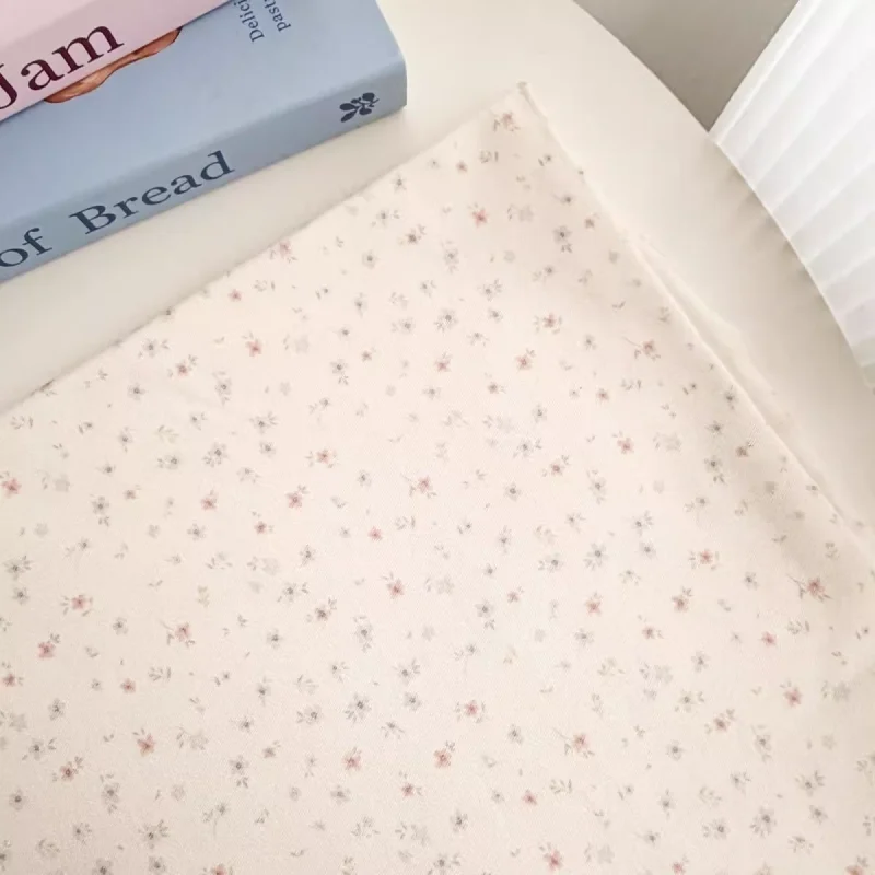 

Polyester cotton beige small floral fabric, used for handmade bags, women's clothing, children's clothing and other fabrics.