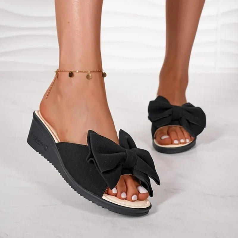 2026 The New Summer Fashionable and Sexy Large-sized Slope Heel Thick-soled Bow One-line Casual Beach Flip-flops for Slippers