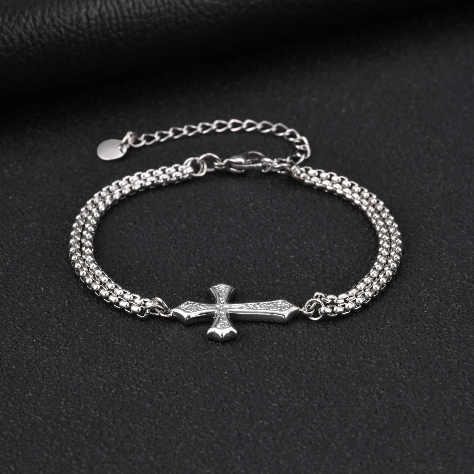 Layered stainless steel cross bracelet detail