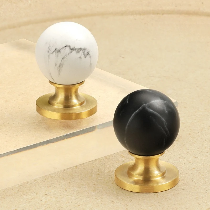 

French-style minimalist brass drawer pulls with marble-printed finish American-style high-end single-hole cabinet door handles