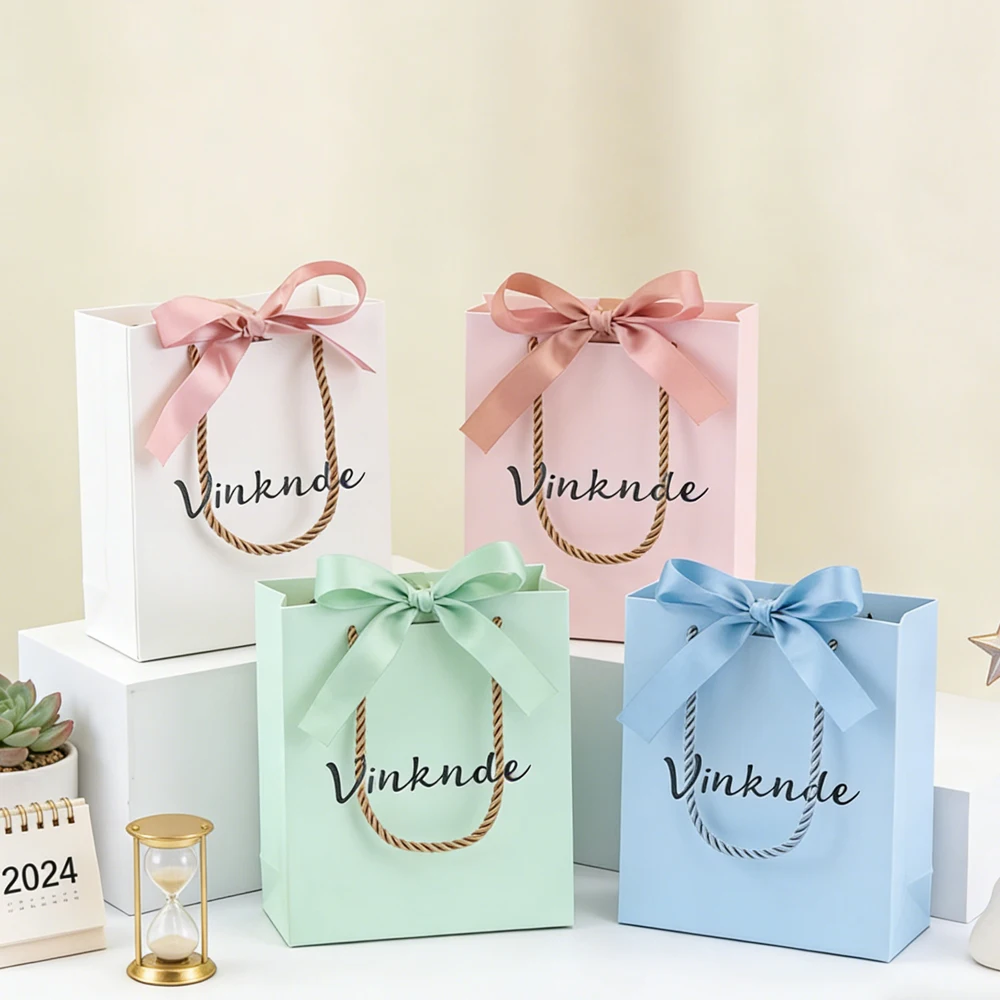 

Wholesale 14x6x17cm Custom Logo Bowknot Handheld Paper Bags for Gift Clothes Shoes Cosmetic Perfume Candy Candle Packaging Bag