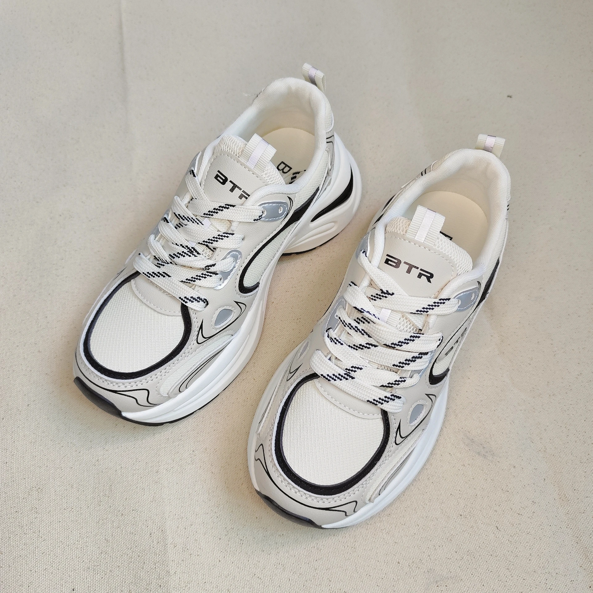 

A Pair of Brown And A Pair of Black Slippers