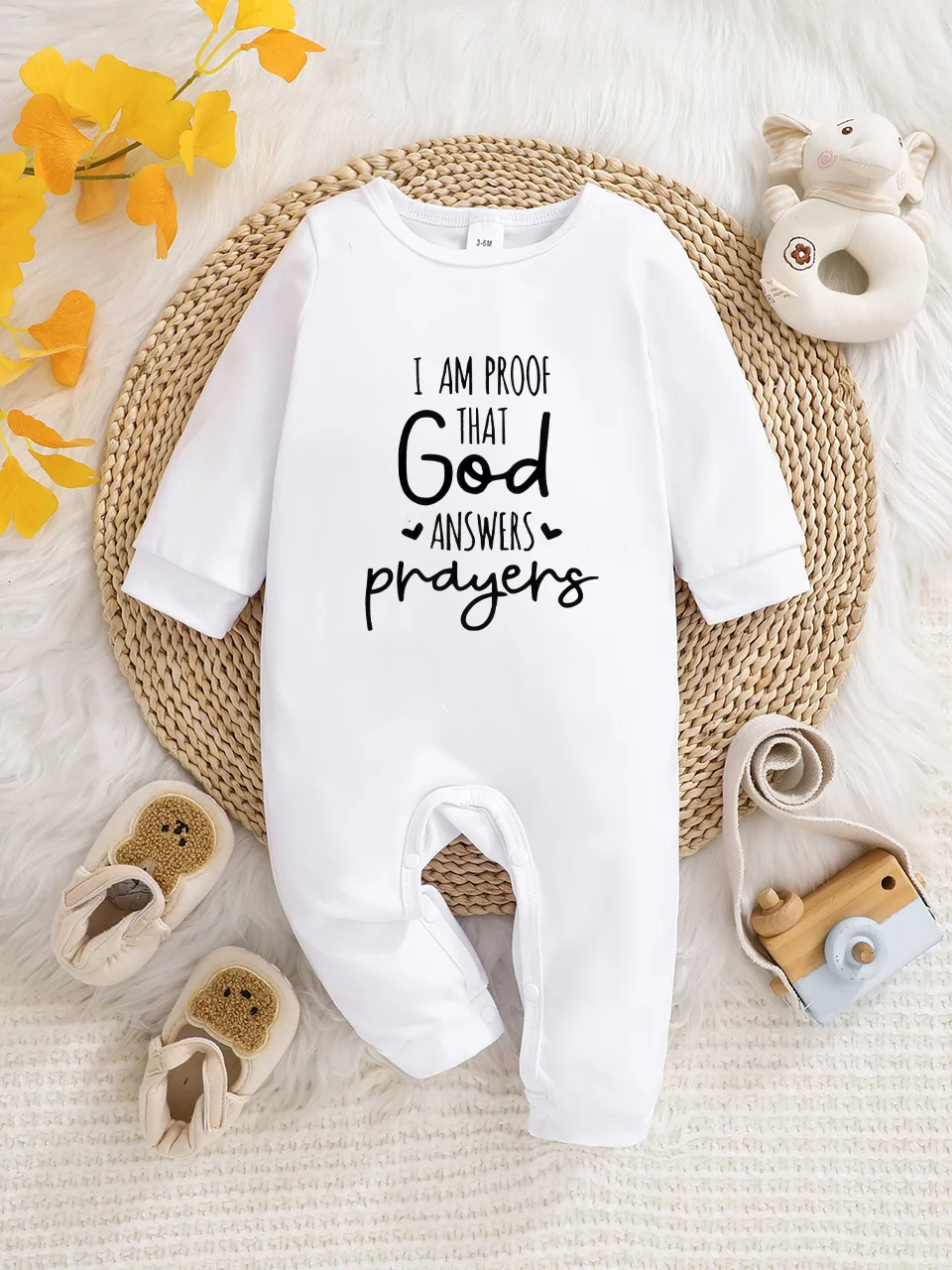 A baby long-sleeved onesie with interesting letter prints. It features a buttoned design for easy putting on and taking off, and